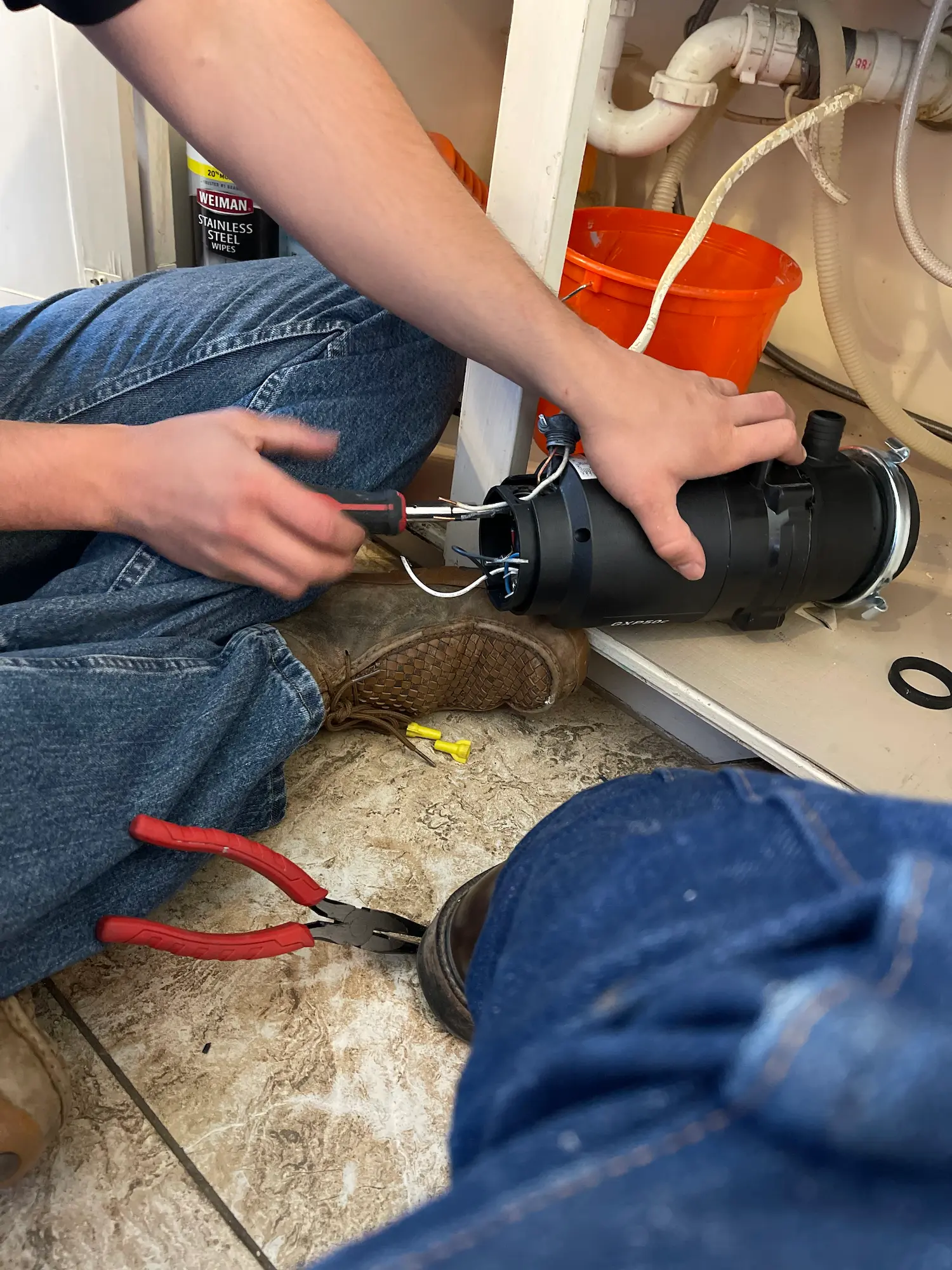 Round Rock plumber servicing a kitchen garbage disposal
